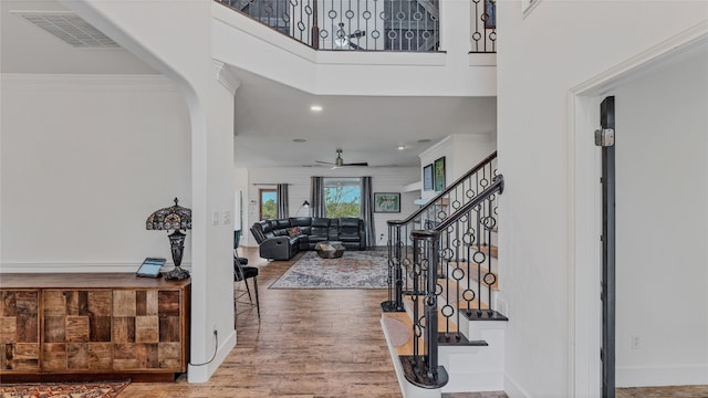 entryway with ornamental molding, hardwood / wood-style floors, and ceiling fan