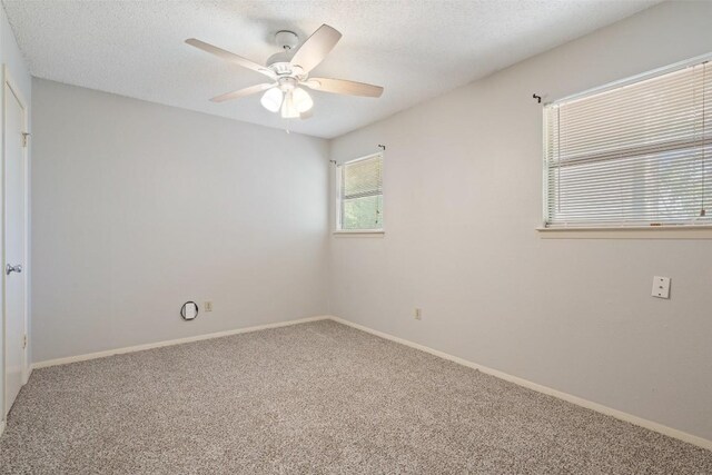 spare room with ceiling fan, carpet floors, and a textured ceiling