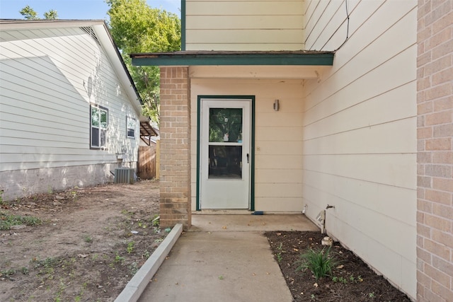 doorway to property featuring central AC unit