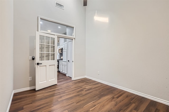 empty room featuring dark hardwood / wood-style flooring