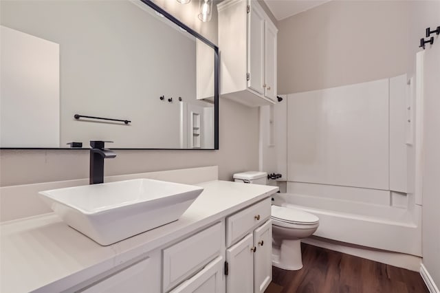 full bathroom with hardwood / wood-style flooring, vanity, toilet, and bathing tub / shower combination