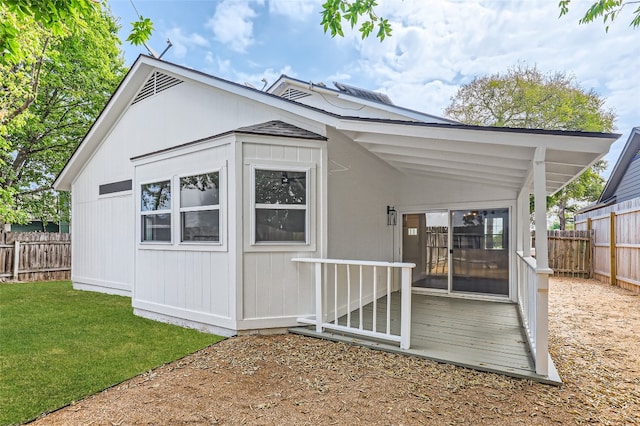 rear view of property with a lawn