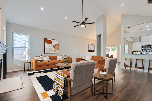 living room featuring ceiling fan, high vaulted ceiling, and dark hardwood / wood-style floors