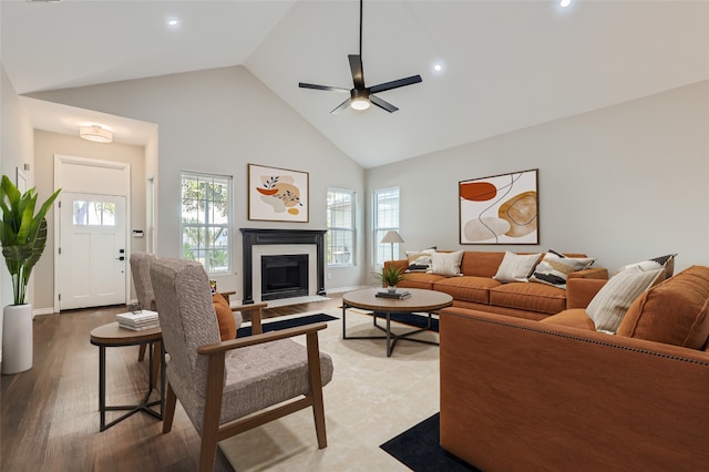 living room with hardwood / wood-style flooring, ceiling fan, a healthy amount of sunlight, and high vaulted ceiling