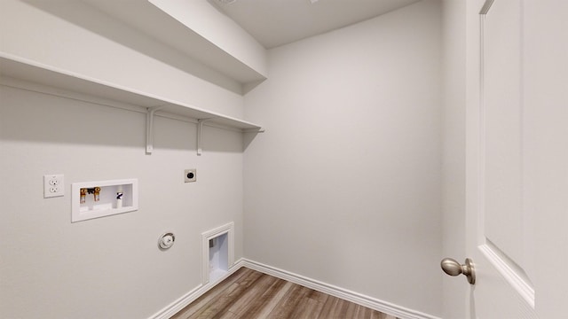 washroom featuring hookup for a washing machine, gas dryer hookup, dark hardwood / wood-style flooring, and hookup for an electric dryer