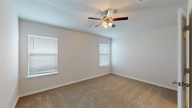 carpeted empty room featuring ceiling fan and plenty of natural light