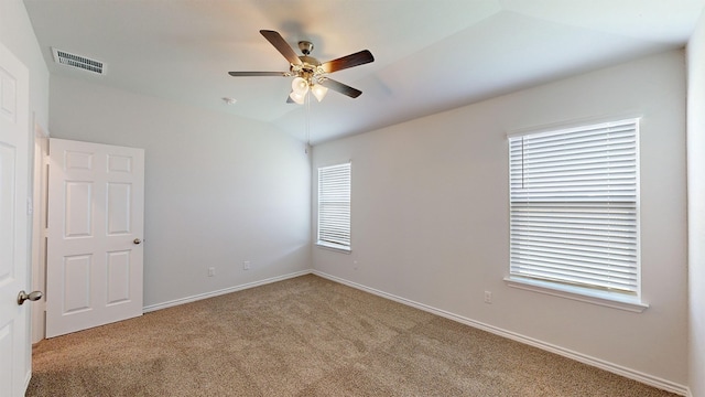 carpeted empty room with lofted ceiling and ceiling fan