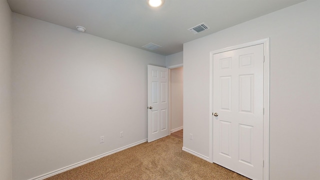 unfurnished bedroom featuring light colored carpet