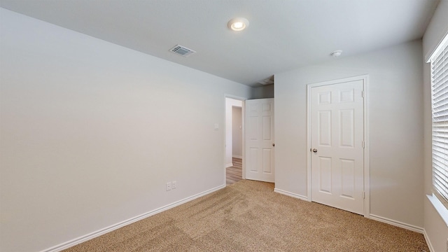 unfurnished bedroom with light carpet