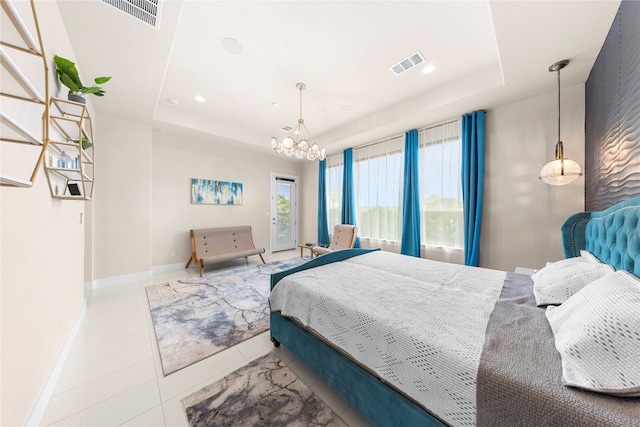 bedroom featuring a chandelier and a raised ceiling