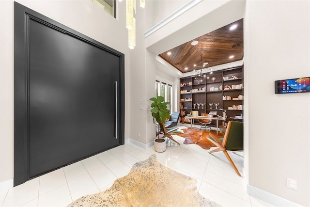 tiled entrance foyer featuring wood ceiling