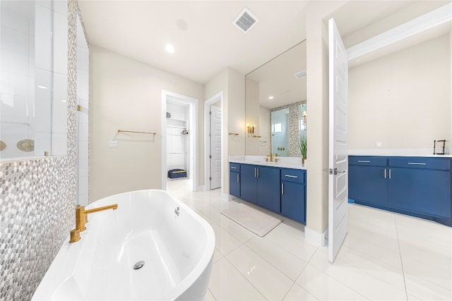 bathroom with plus walk in shower, tile patterned floors, and vanity