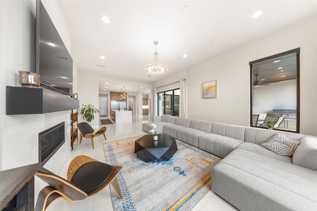 tiled living room featuring a chandelier