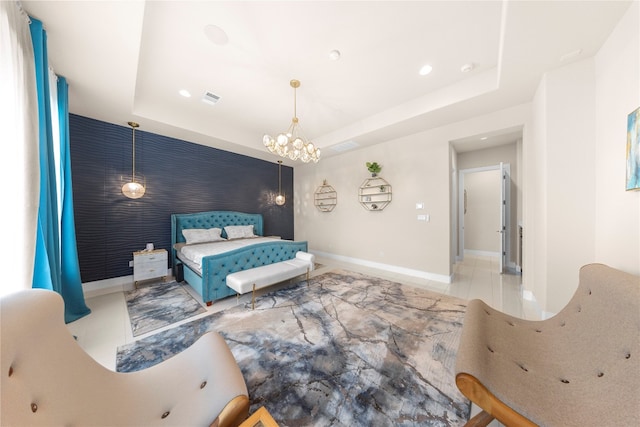 bedroom with a tray ceiling and a chandelier