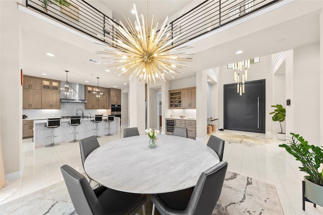 tiled dining room with a notable chandelier and beverage cooler