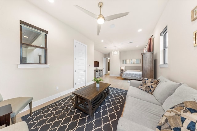 living room featuring hardwood / wood-style floors and ceiling fan