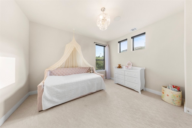 carpeted bedroom with a chandelier