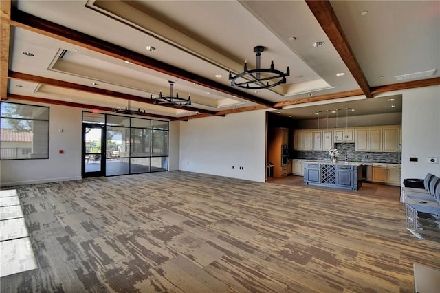 unfurnished living room featuring beamed ceiling, a tray ceiling, and light hardwood / wood-style flooring