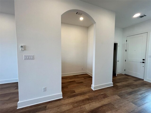 spare room featuring dark wood-type flooring