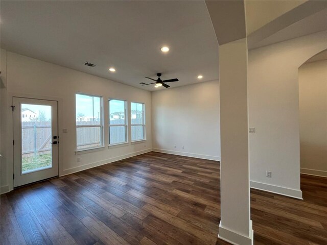 empty room with ceiling fan and dark hardwood / wood-style flooring