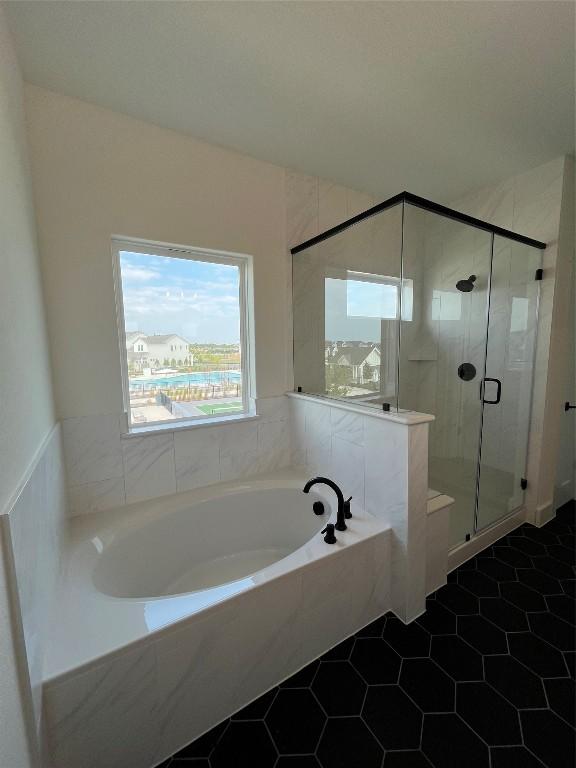 bathroom with tile patterned flooring and independent shower and bath