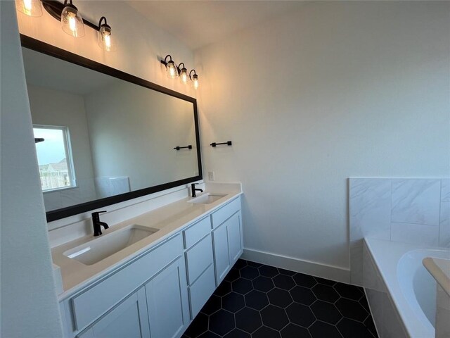 bathroom featuring a tub, vanity, and tile patterned floors