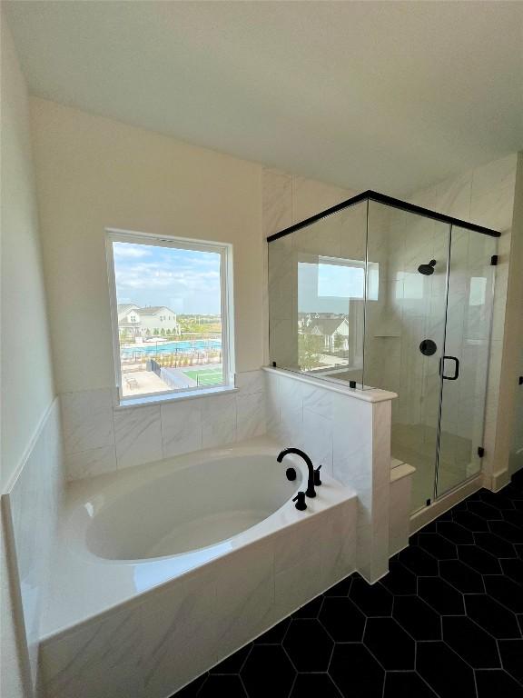 bathroom featuring shower with separate bathtub and tile patterned floors