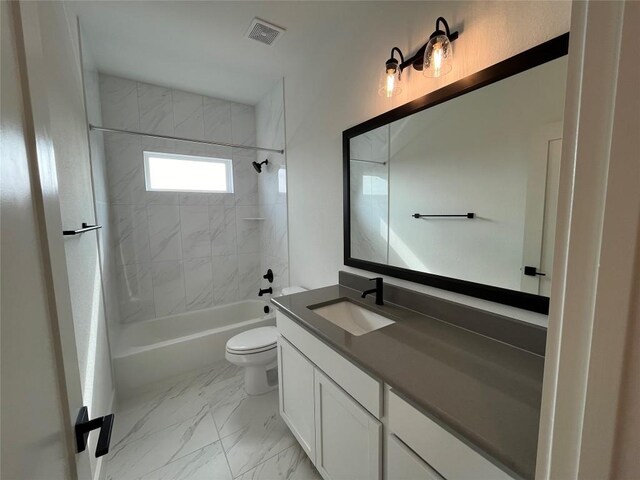 full bathroom featuring vanity, toilet, and tiled shower / bath