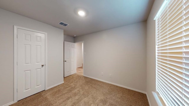 unfurnished bedroom featuring light colored carpet