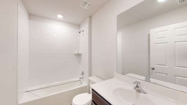 full bathroom with vanity, tiled shower / bath, and toilet