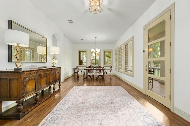14 Margranita Cres, Austin, TX 78703 - dining room featuring a chandelier, wood finished floors, and baseboards