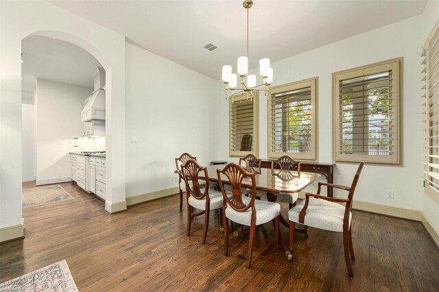 dining area with an inviting chandelier and dark wood-type flooring