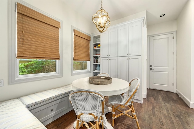 dining area featuring dark hardwood / wood-style flooring and a chandelier