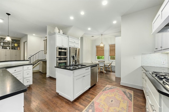 14 Margranita Cres, Austin, TX 78703 - kitchen featuring stainless steel appliances, a sink, dark countertops, an island with sink, and recessed lighting