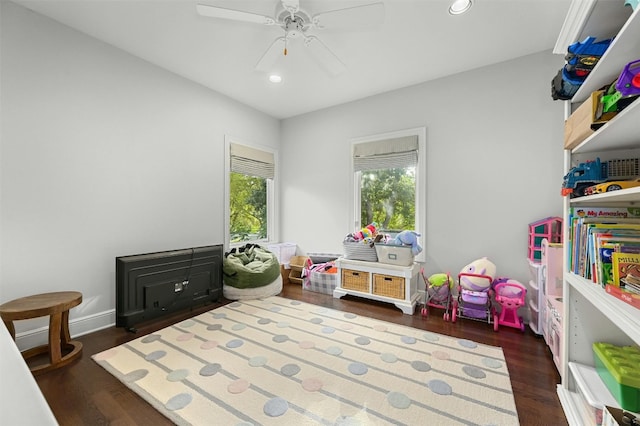 game room with dark wood-type flooring, recessed lighting, ceiling fan, and baseboards