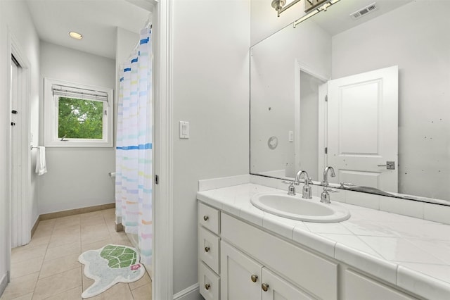 14 Margranita Cres, Austin, TX 78703 - full bathroom featuring vanity, tile patterned flooring, baseboards, and a shower with shower curtain