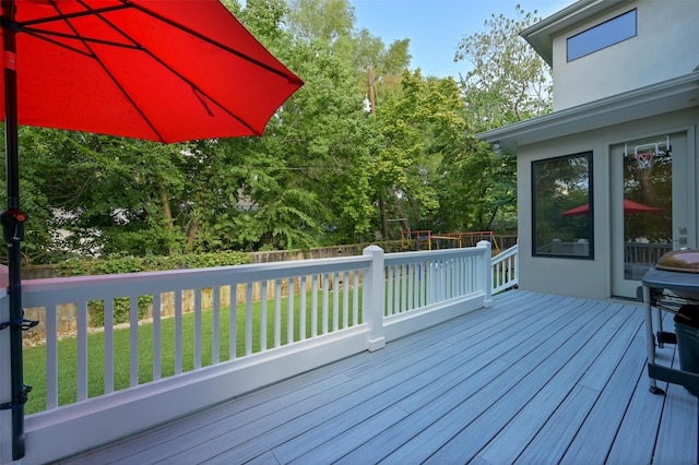 deck featuring a lawn and fence