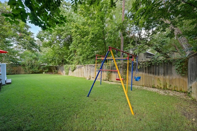 view of jungle gym featuring a fenced backyard and a lawn