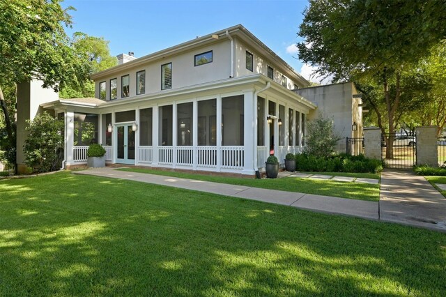 exterior space with a sunroom and a front yard