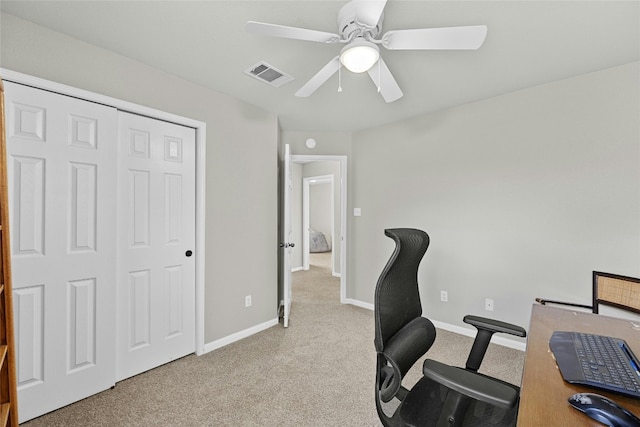 office space with ceiling fan and light colored carpet