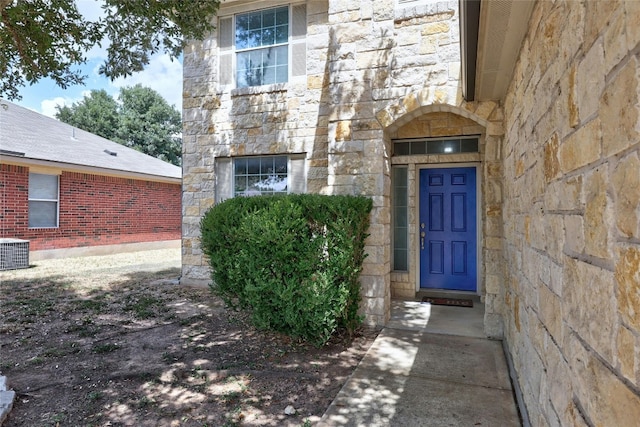 view of exterior entry featuring central AC unit