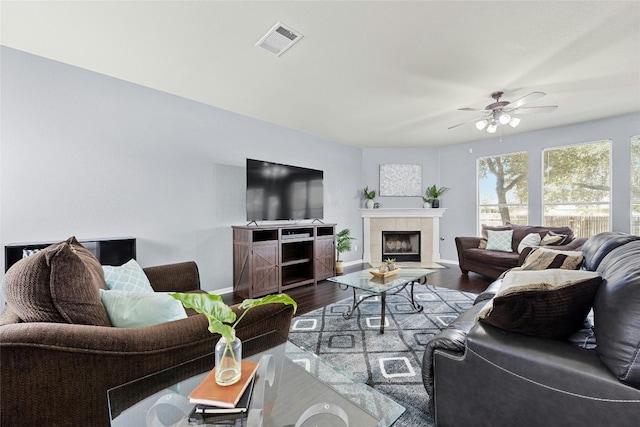 living room with ceiling fan, a fireplace, and hardwood / wood-style floors