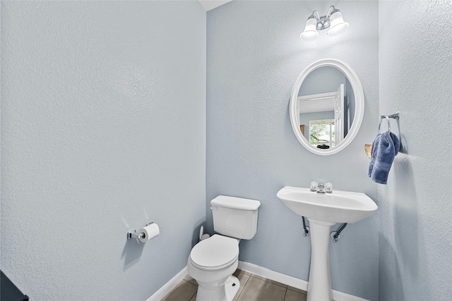 bathroom with tile patterned flooring and toilet