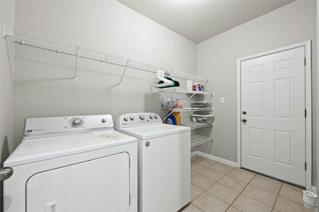 laundry area with light tile patterned flooring and washing machine and dryer