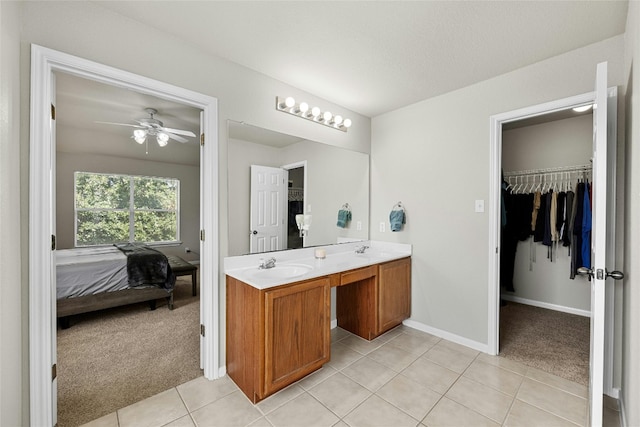 bathroom with tile patterned floors, ceiling fan, and vanity