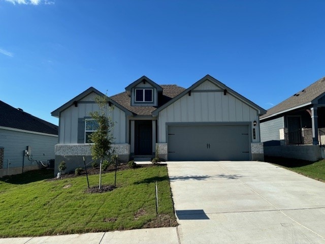 craftsman-style house with a front yard and a garage