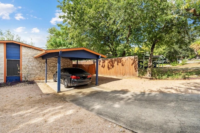 view of parking / parking lot featuring a carport