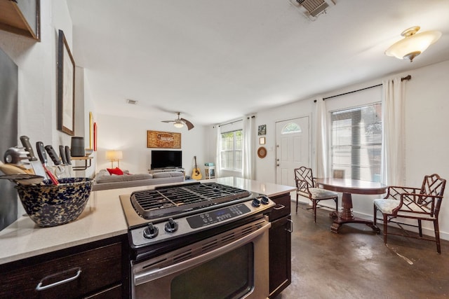 kitchen featuring dark brown cabinetry, stainless steel range, and ceiling fan