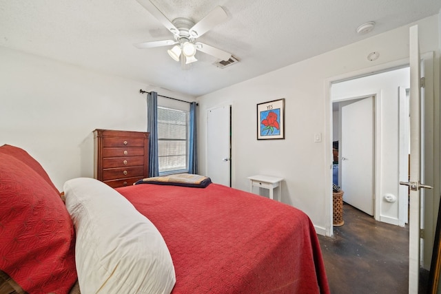 bedroom with ceiling fan and a textured ceiling