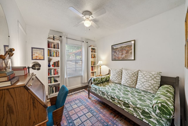 interior space featuring ceiling fan, dark hardwood / wood-style floors, and a textured ceiling